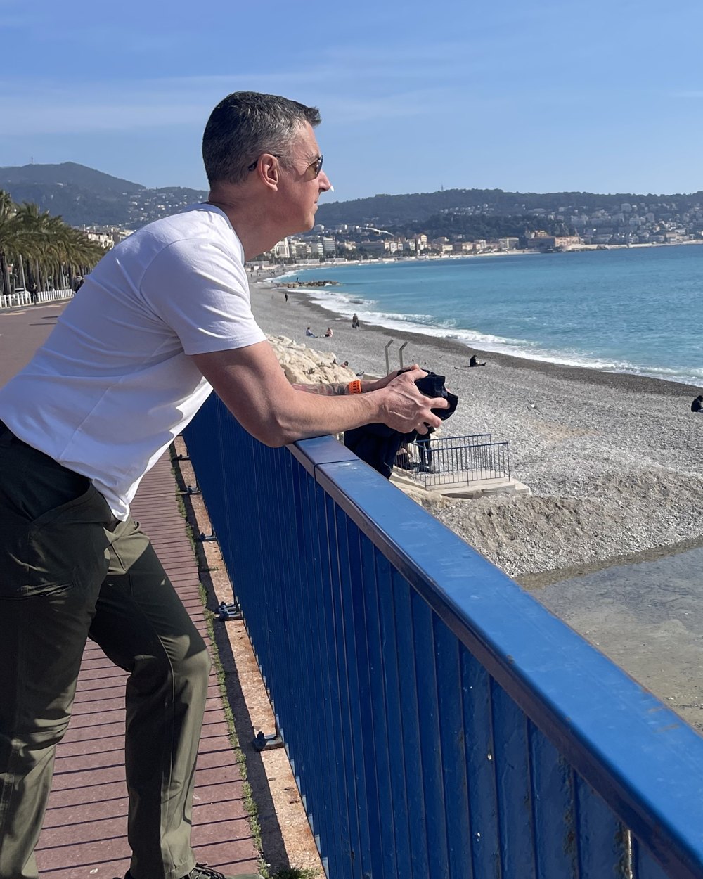 Dave Raney leaning on a railing, looking out at the sea